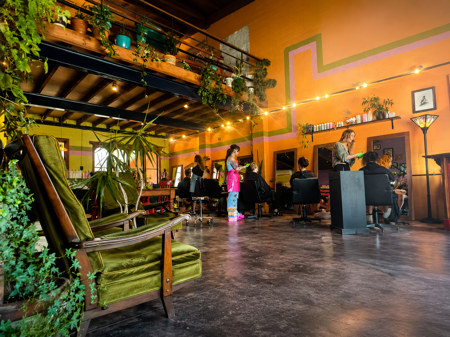 Hairjesus colourful salon interior with plants and styling stations
